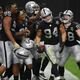 Defensive end Carl Nassib, who recently came out, celebrates with Raiders teammates after he intercepted a Denver Broncos’ pass in the second half of their game at Allegiant Stadium on November 15, 2020, in Las Vegas.